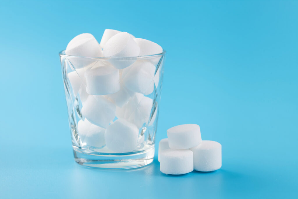The tableted salt for the system of filtration of water on a blue background