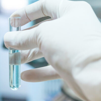 Test tube in scientist hand in laboratory