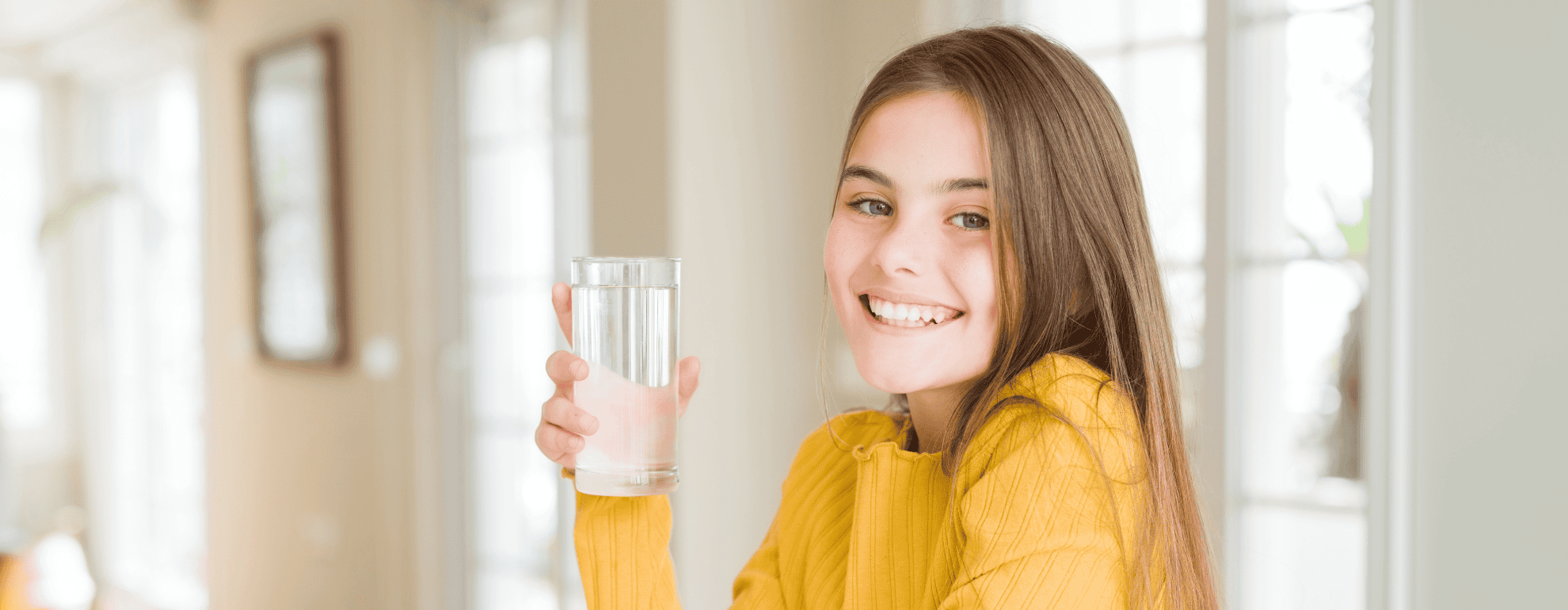 young girl drinking glass of RO water in OKC home