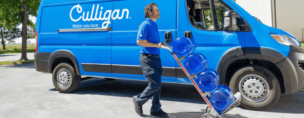 Culligan Man Delivery Bottled Water On a Dolly